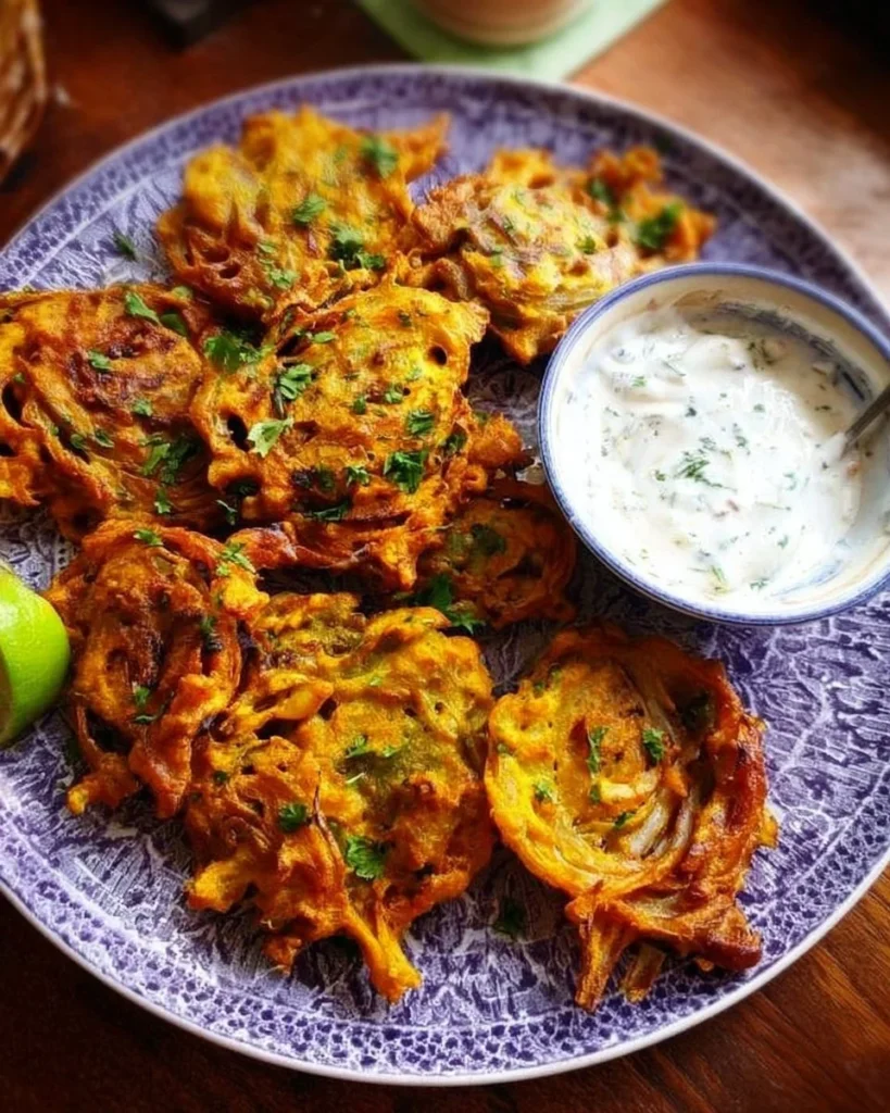 Delicious Indian onion fritters served on a plate, crispy and golden brown.