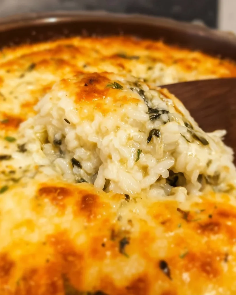 Spinach and Artichoke Rice Casserole in a baking dish garnished with herbs