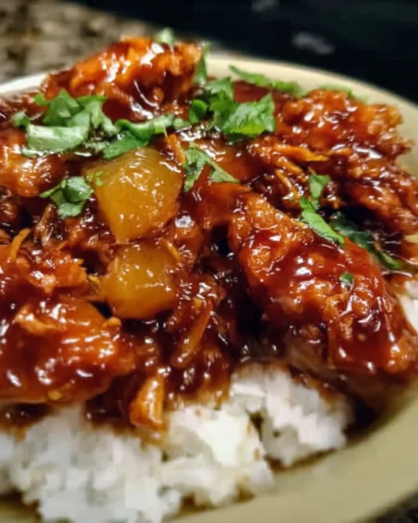 Delicious Sweet Hawaiian Crockpot Chicken served with rice and pineapple.