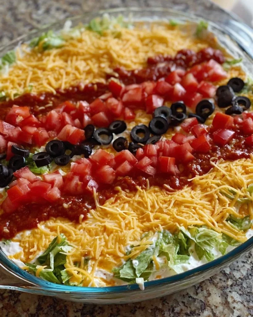 Delicious Taco Salad Dip served in a colorful bowl with fresh toppings.