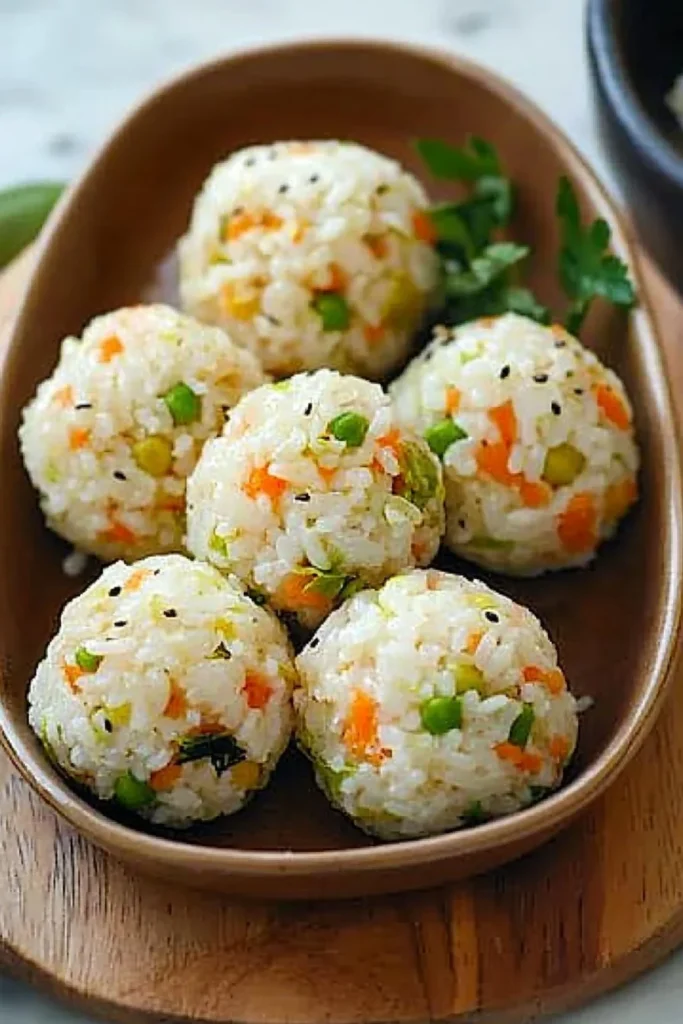 Delicious veggie rice balls on a plate, showcasing various vibrant colors and ingredients.