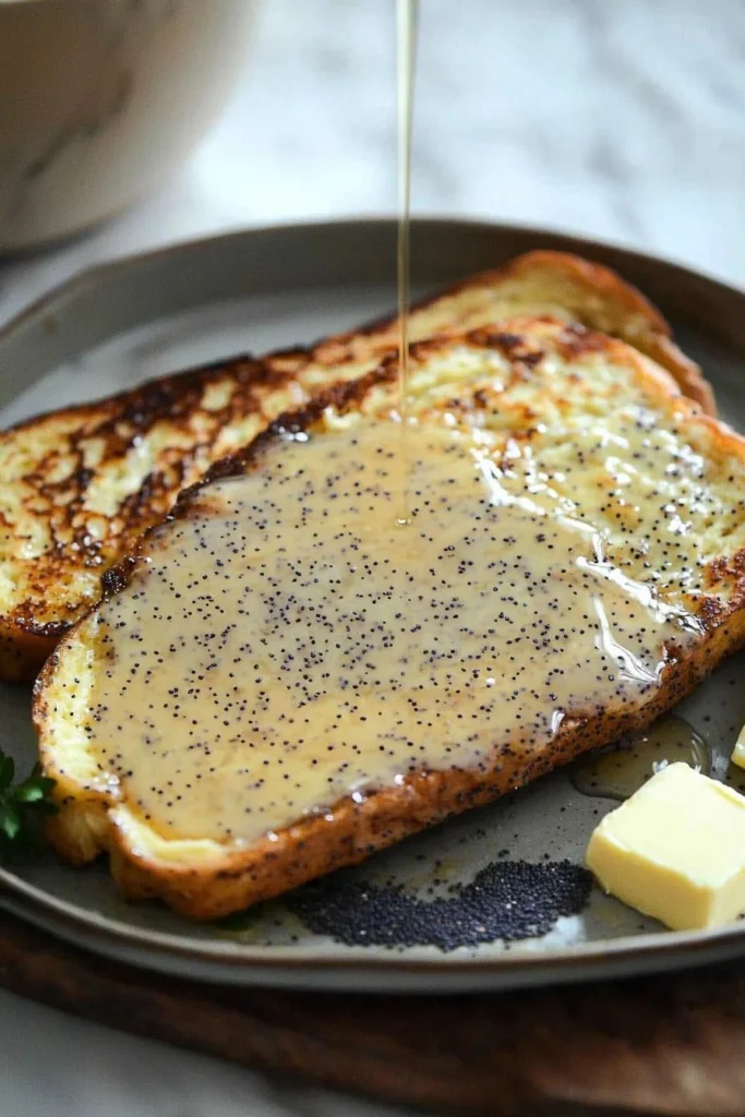 Almond Poppy Seed French Toast topped with syrup and fresh berries