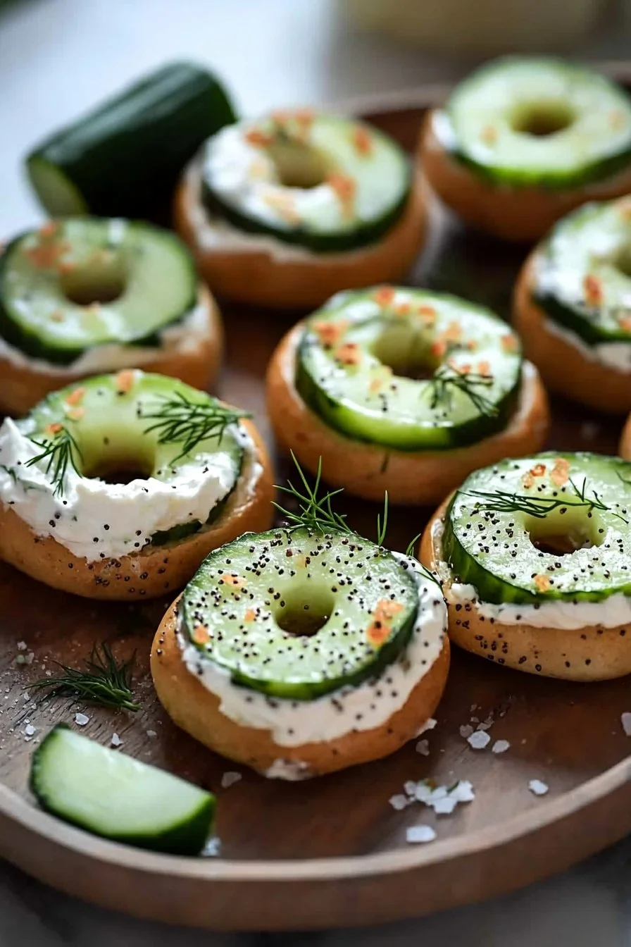 Plate of Bagel Cucumber Bites topped with cream cheese and herbs