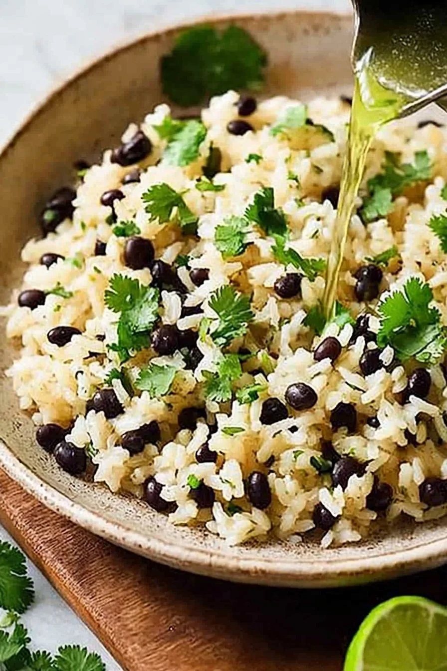 Cilantro-Lime Black Bean Rice served in a bowl garnished with fresh herbs