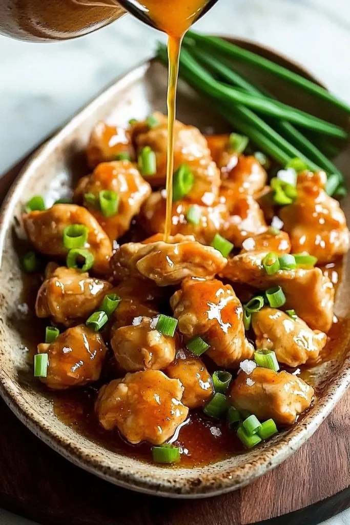 Delicious plate of homemade orange chicken garnished and served with rice.