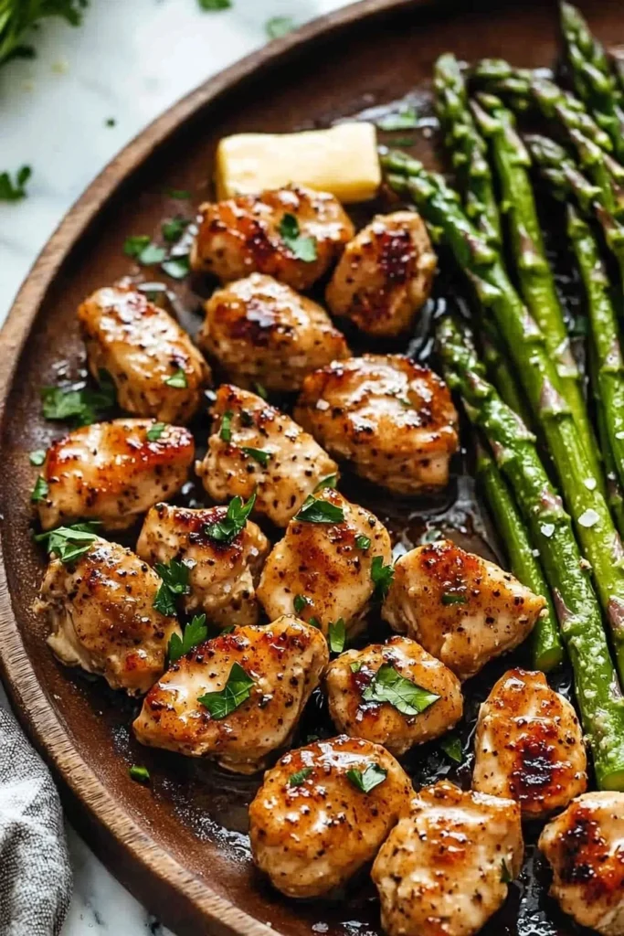 Garlic Butter Chicken Bites with Asparagus served on a plate