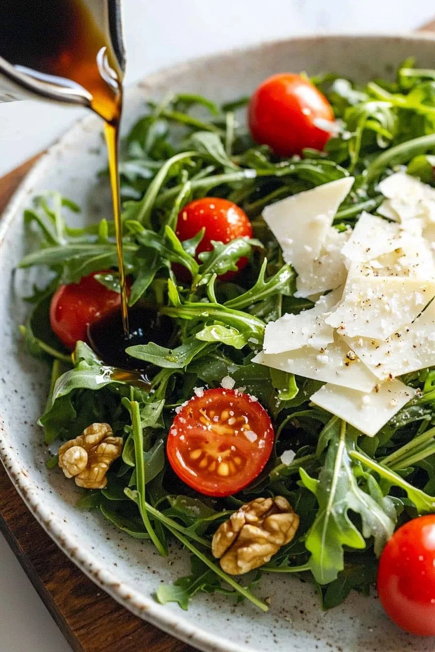 Fresh arugula salad topped with grated Parmesan cheese