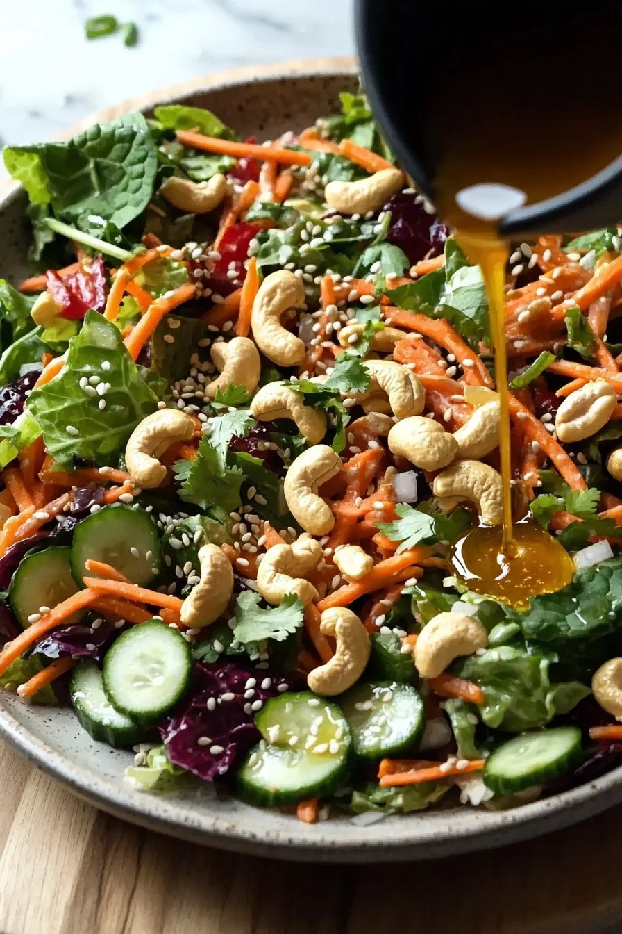 Cashew Crunch Salad with Sesame Dressing topped with crunchy cashews and colorful vegetables
