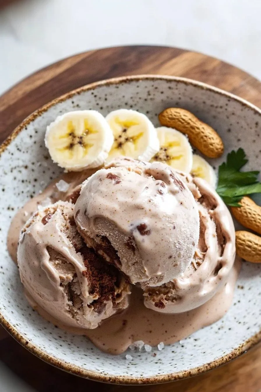 Chocolate Fudge Peanut Butter Protein Ice Cream in a bowl with a spoon.