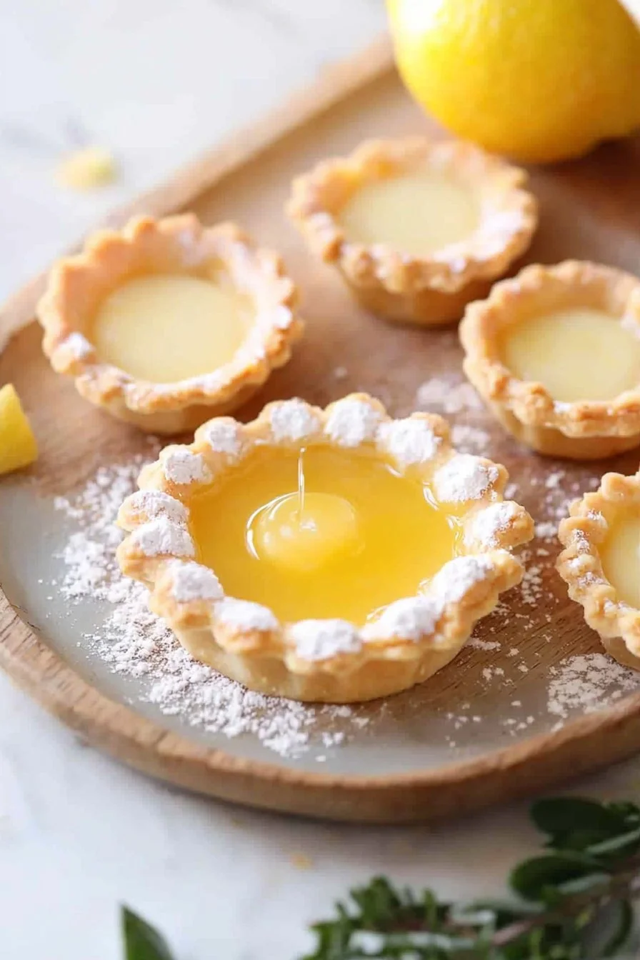Delicious homemade lemon curd tartlets on a white plate