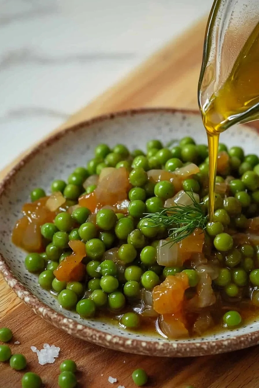 Delicious Greek braised peas cooked in olive oil, garnished with herbs.