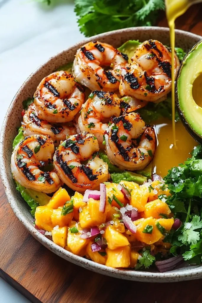 Delicious grilled prawns in avocado bowls topped with mango salsa