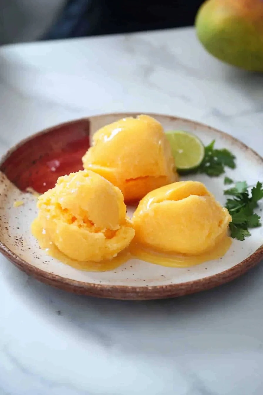 Delicious homemade mango sorbet served in a bowl with mint leaves