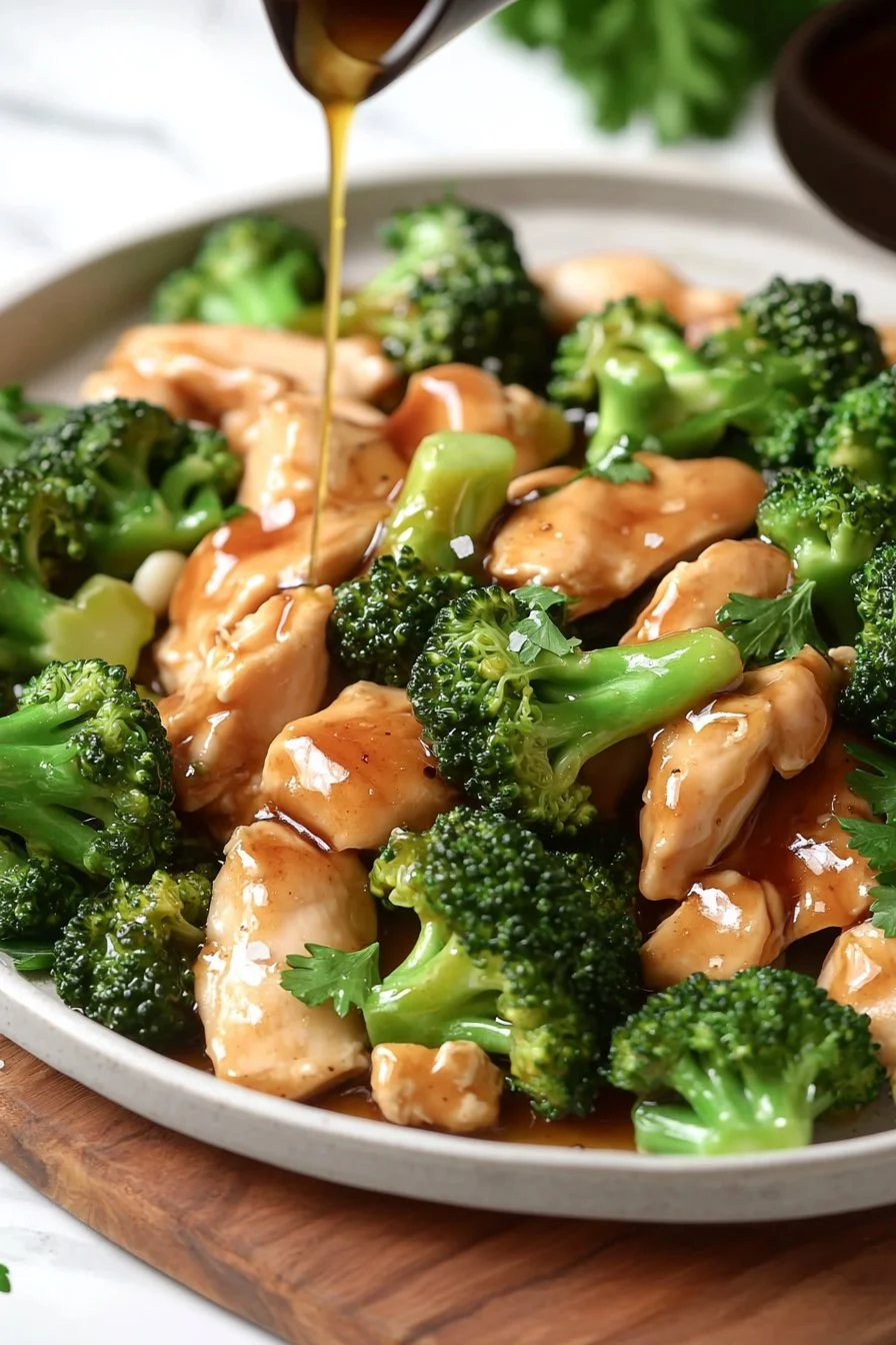 Plate of Chicken and Broccoli served with rice and vegetables