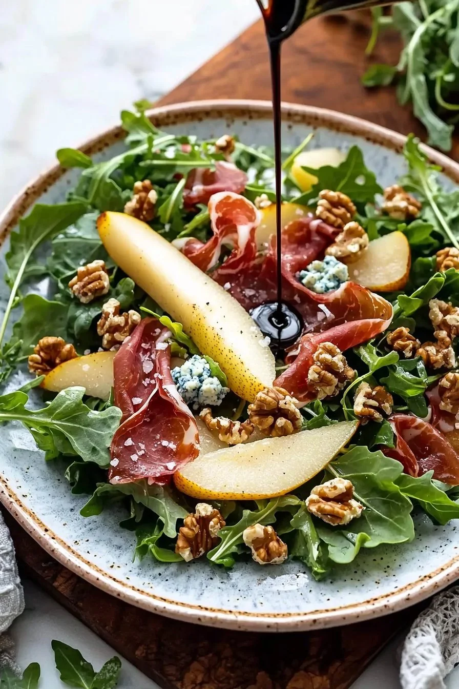 Delicious pear and prosciutto salad served with greens and balsamic dressing