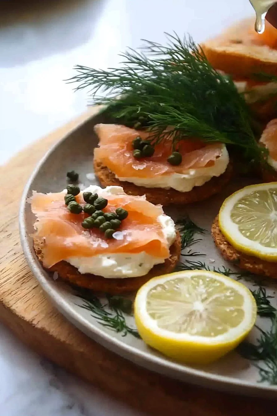 Delicious smoked salmon and cream cheese canapés on a platter.