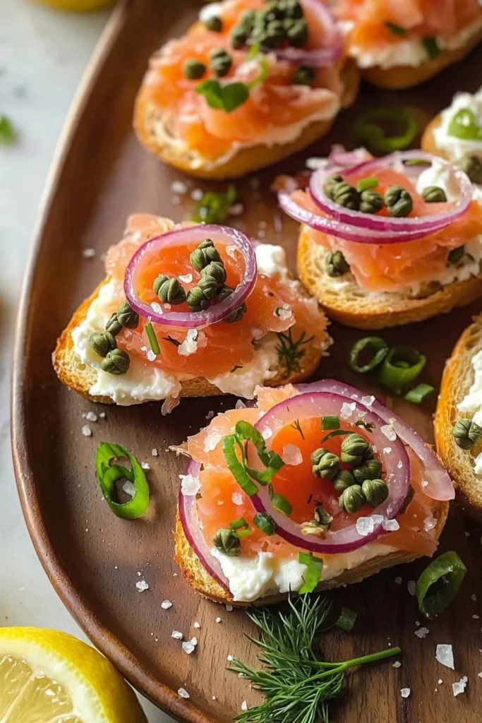 Smoked salmon crostini topped with cream cheese and herbs