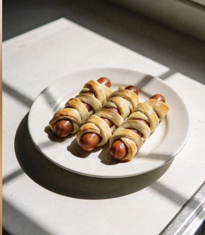 Spooky mummy hot dogs wrapped in dough, perfect for Halloween snacks.