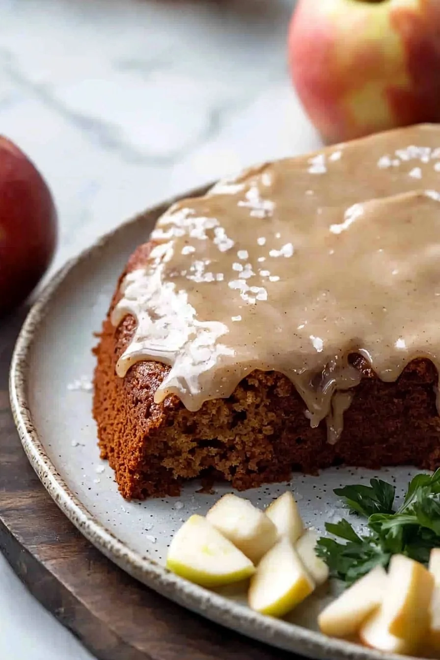 Slice of Apple Spice Cake with Brown Sugar Icing on a plate
